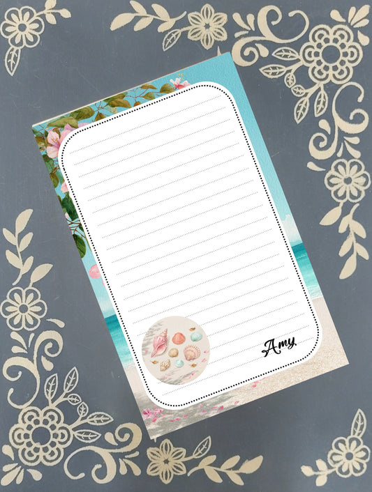 Personalized notepad featuring a tropical summer beach shells design, showing lined tear-away sheets by Mrs B's Stationery & Gift Shop.