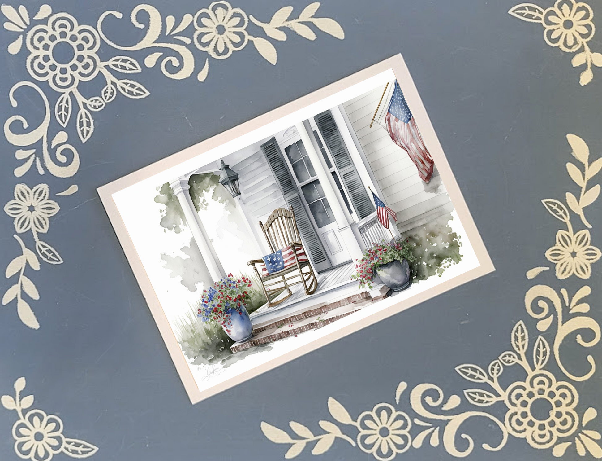 Decorative postcard with a porch scene featuring American flags on a blue background with floral border.