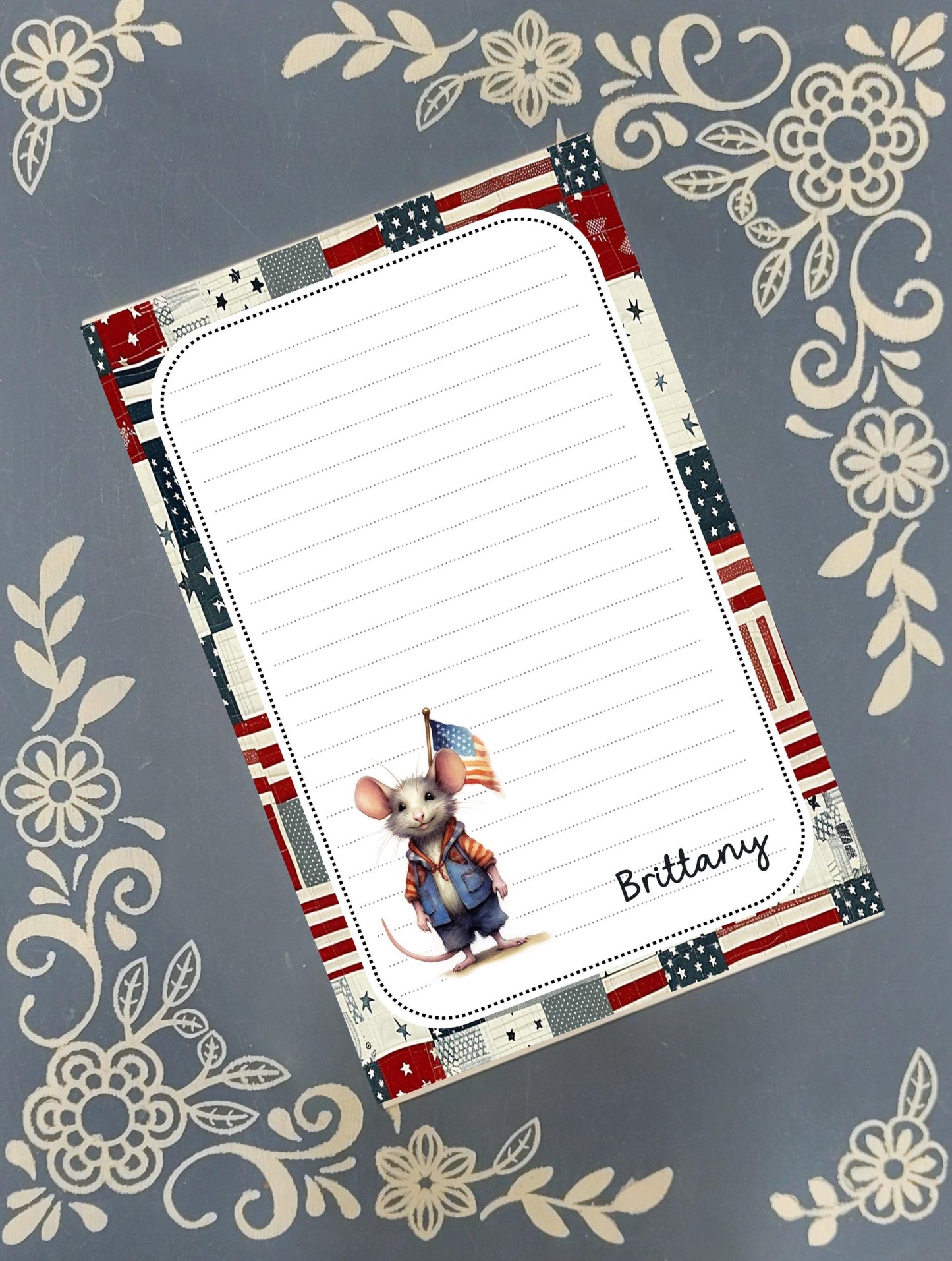 Personalized custom notepad featuring a cute, whimsical patriotic USA mouse illustration with a personalized name on a rustic desk.